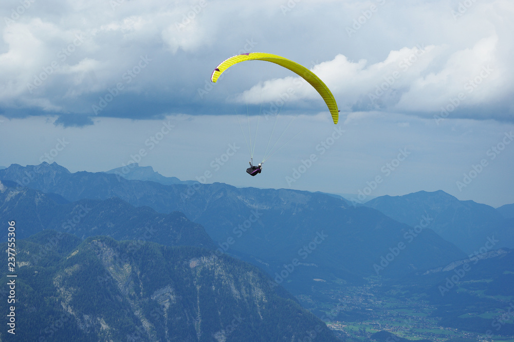 Paraplane over the Austrian Alps under stormy clouds region Dachstein in the Austrian state of Styria Paraplane over the Austrian Alps under stormy clouds region Dachstein in the Austrian state of Styria