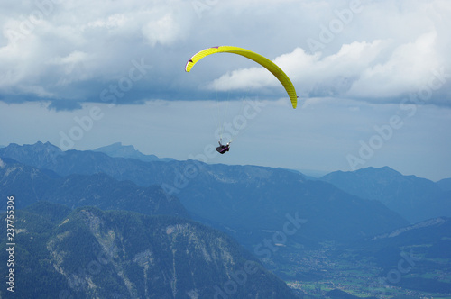 Paraplane over the Austrian Alps under stormy clouds region Dachstein in the Austrian state of Styria