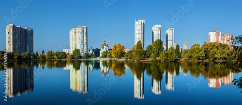 Cityscape church and houses with reflections in the water © Oleg