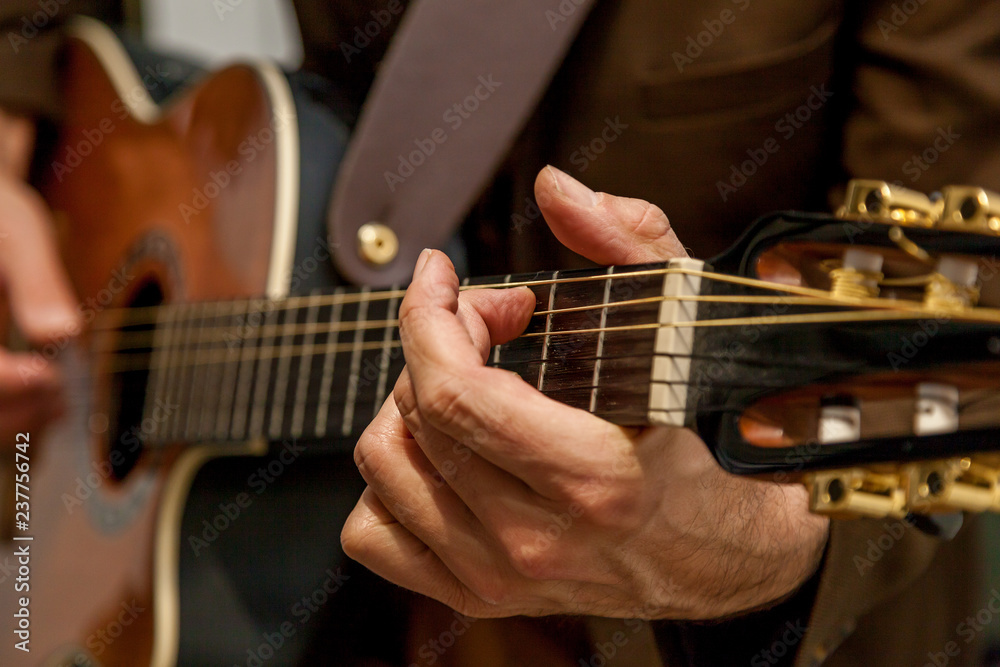 musician plays guitar close up