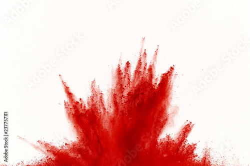 Freeze motion of red powder exploding, isolated on white background. Abstract design of red dust cloud. Particles explosion screen saver, wallpaper