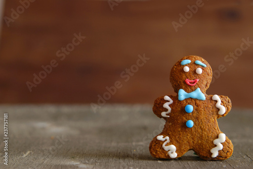 Gingerbread man on a wooden background.