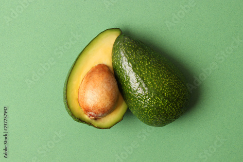  Avocado fruit on a colored background top view.