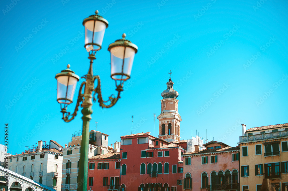 View og the old lantern in front of the colorful buildings in Venice, Italy