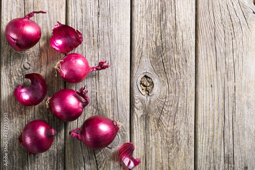 spanish onions on old rustic wood table background, top view