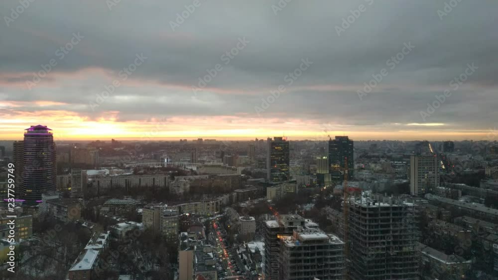 Sunset over the city. Clouds slowly float over the city. View of the evening city. Time laps Sunset over the city. Clouds slowly float over the city. View of the evening city. Time laps