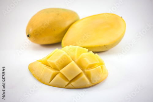 Yellow mango and mango slice with cubes isolated white background