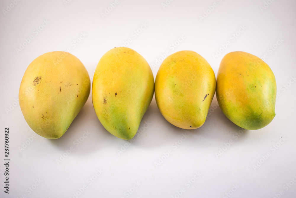 Four vietnamess mangoes on white background
