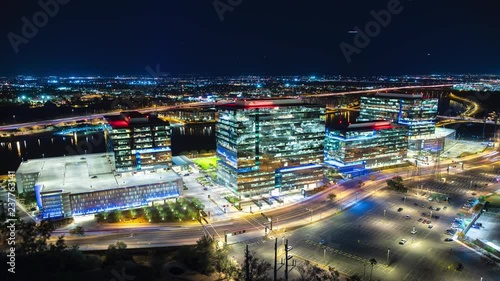 Tempe AZ Business Exterior Night Generic Timelapse View Over the Salt River with Modern Architecture and Approaching Aircraft in a Clear Blue Arizona Evening Sky photo