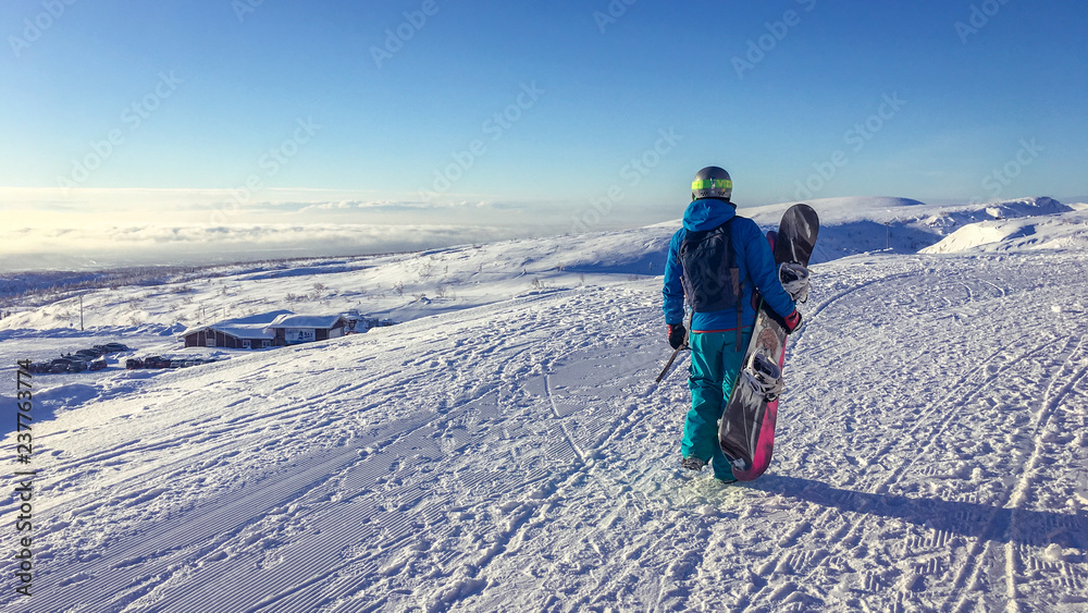 man with snowboard on mountain