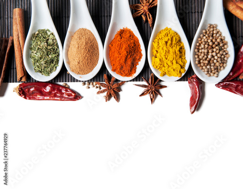 Top view on mixed dry colorful spices isolated on white background.
