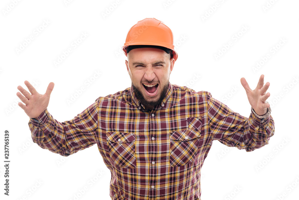 An angry and nervous worker in an orange helmet is talking loudly. Isolated white background An angry and nervous worker in an orange helmet is talking loudly. Isolated white background