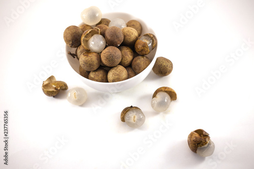 Fresh longan fruits in a white bowl isolated on white background
