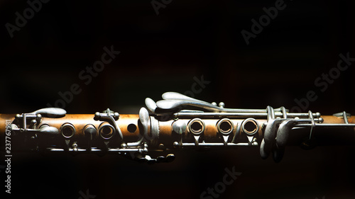 Stampa su tela Ancient clarinet. Detail on a black background