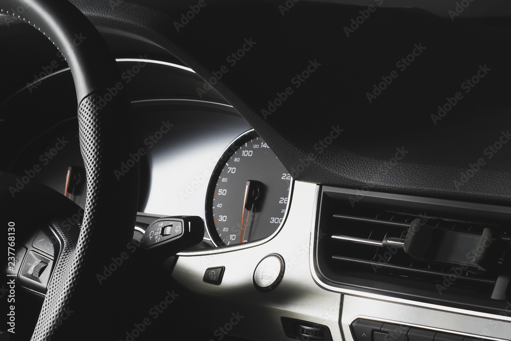 Dark car dashboard. Speedometer up to 300. holder for the phone on the air deflector duct.