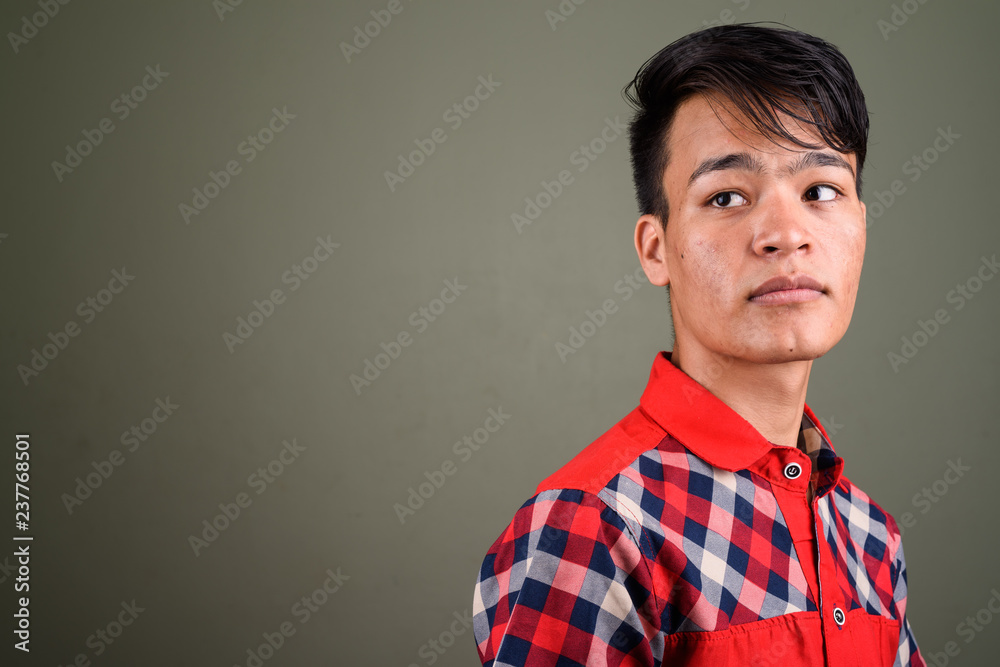 Young handsome Indian man against colored background Young handsome Indian man against colored background