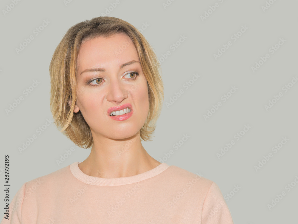 photo of aggressive attractive young caucasian woman with short hair with angry face expression.  isolated on white background