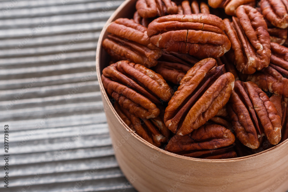 Fototapeta premium delicious pecan nuts on a rustic wooden background