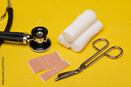 Plaster bandage roll and scissors