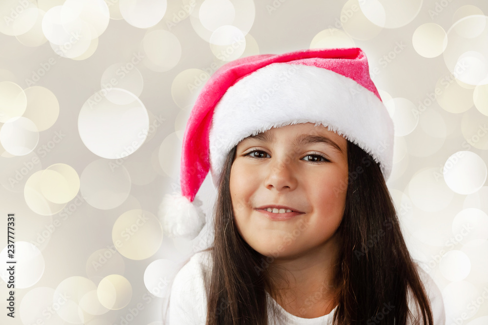 Happy cheerful child girl in Santa Claus Hat. Christmas time. Happy cheerful child girl in Santa Claus Hat. Christmas time.