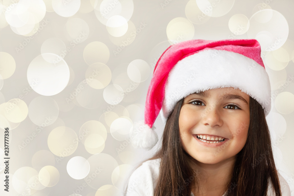 Happy cheerful child girl in Santa Claus Hat. Christmas time. Happy cheerful child girl in Santa Claus Hat. Christmas time.