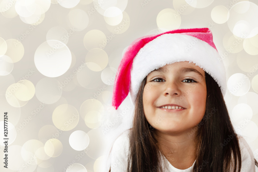 Happy cheerful child girl in Santa Claus Hat. Christmas time. Happy cheerful child girl in Santa Claus Hat. Christmas time.