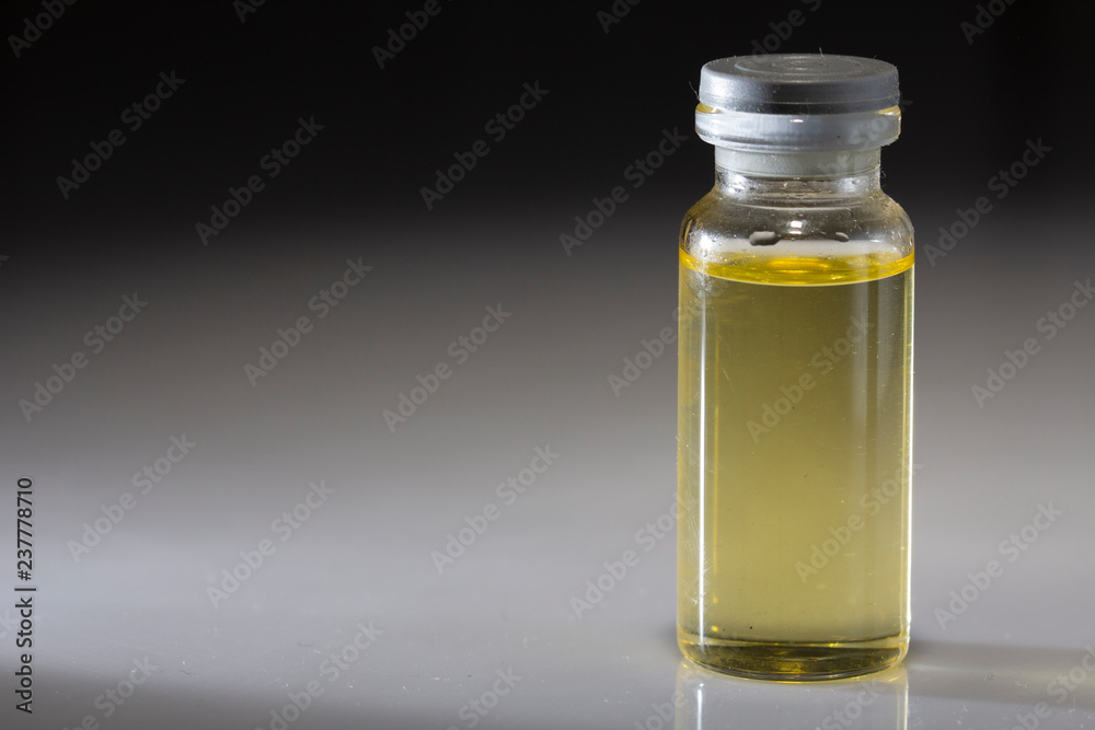small medical butylochka, with yellow inside, on a black background, close-up, small medical butylochka, with yellow inside, on a black background, close-up,