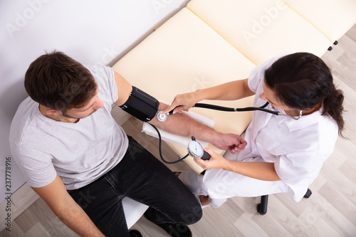 Doctor Measuring Blood Pressure Of Patient