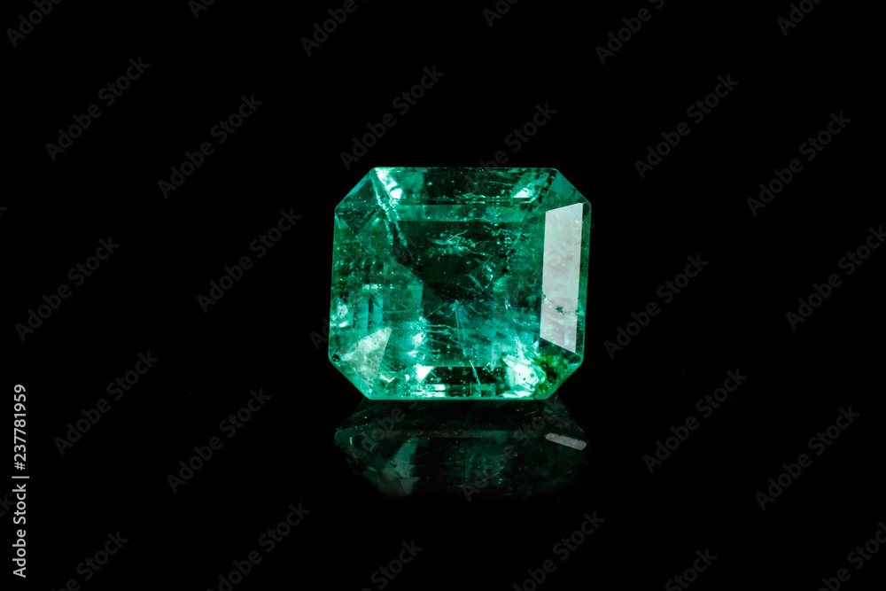 Macro mineral Emerald gemstone faceted on black background Macro mineral Emerald gemstone faceted on black background