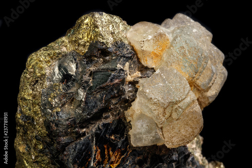 Macro of a mineral stone Sphalerite with fluorite and pyrite on a black background close up