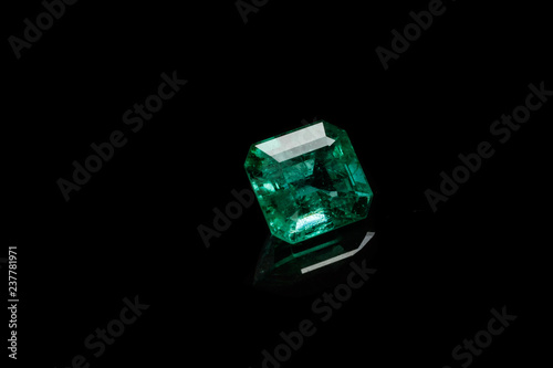 Macro mineral Emerald gemstone faceted on black background