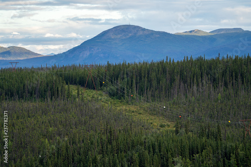 Visibility marker balls on power lines make make the electrial conductor crossings visible to aircraft in Alaska. Boreal forest and the Wrangell mountain range in background © MelissaMN