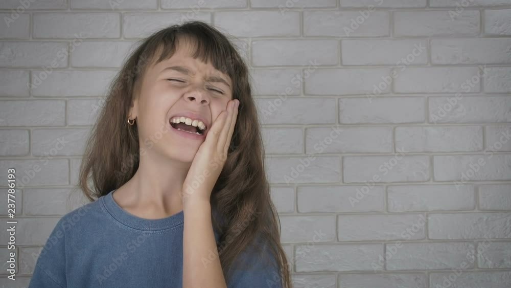 Teeth pain. Toothache. A little girl suffers from a toothache. Teeth pain. Toothache. A little girl suffers from a toothache.