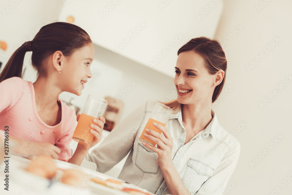 Mom With Daughter Are Having A Dinner At Kitchen. Mom With Daughter Are Having A Dinner At Kitchen.