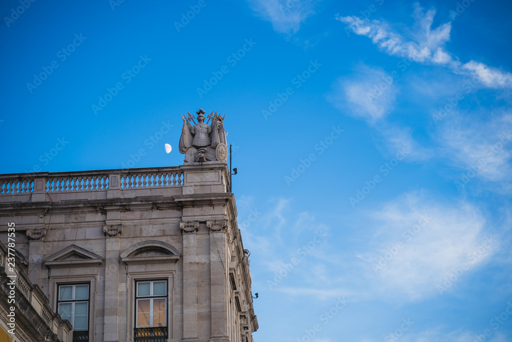 Moon over old building