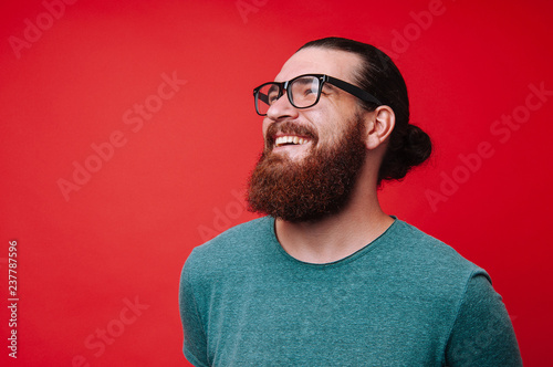 Portrait of cheerful bearded man and lokking away