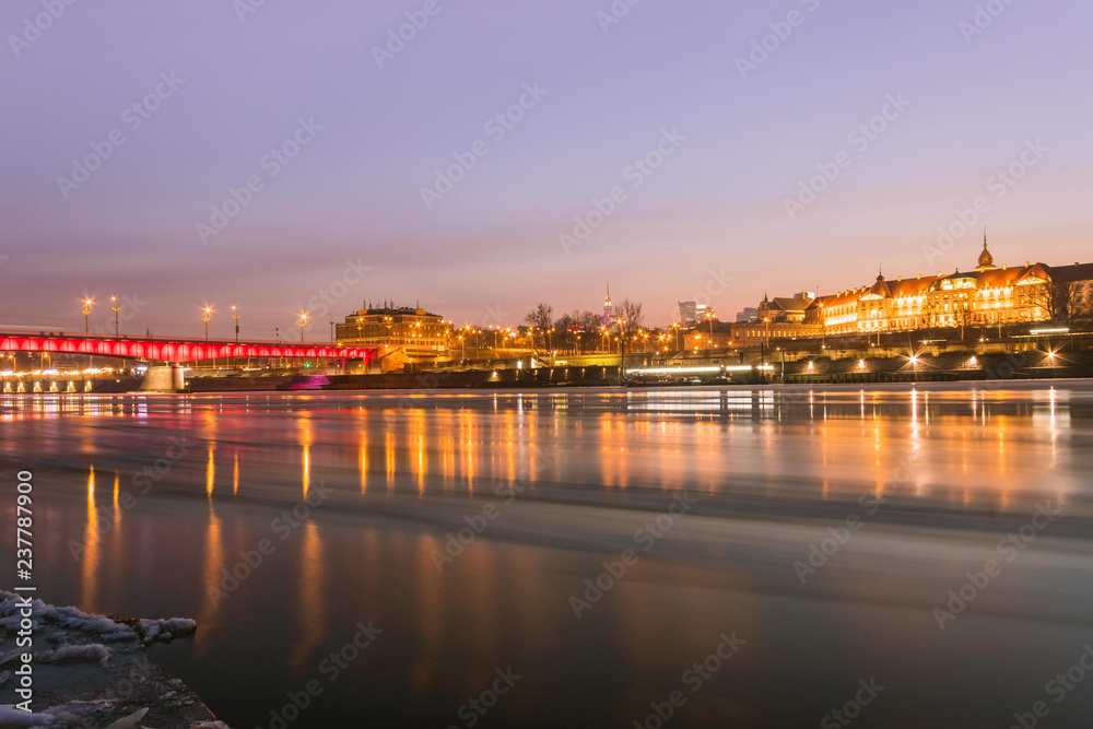 Warsaw skyline with reflection in the Vistula river by night
