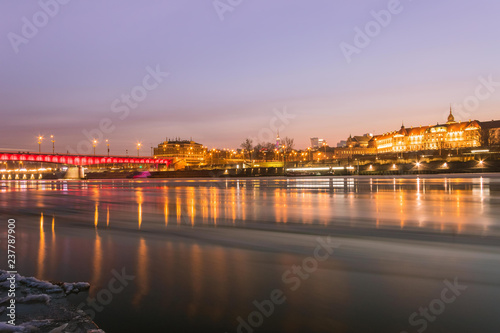 Warsaw skyline with reflection in the Vistula river by night