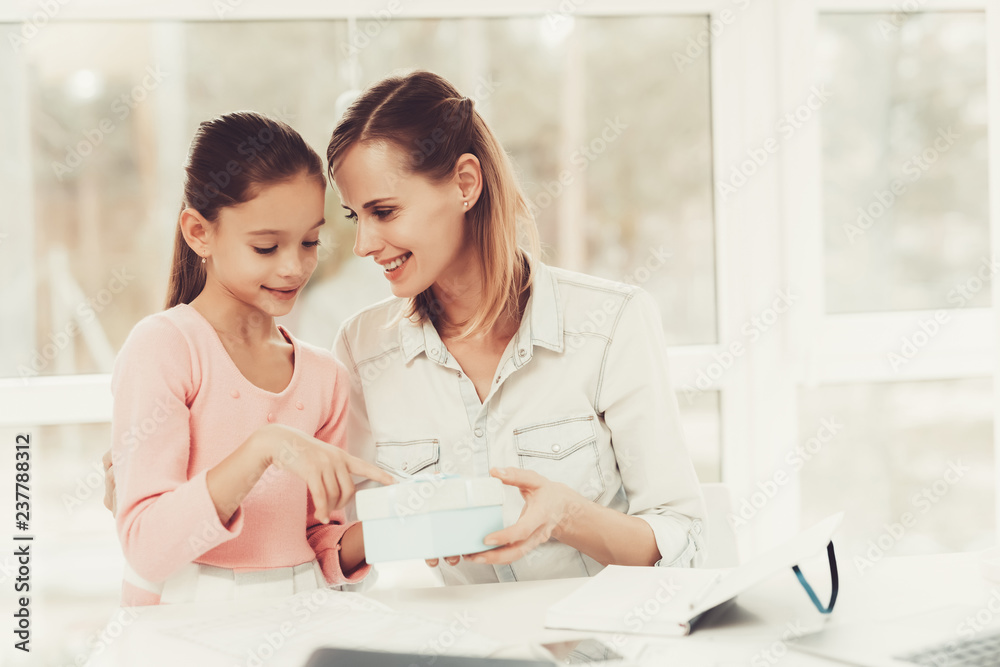Young Daughter With Mom. Present Giving Concept. Young Daughter With Mom. Present Giving Concept.