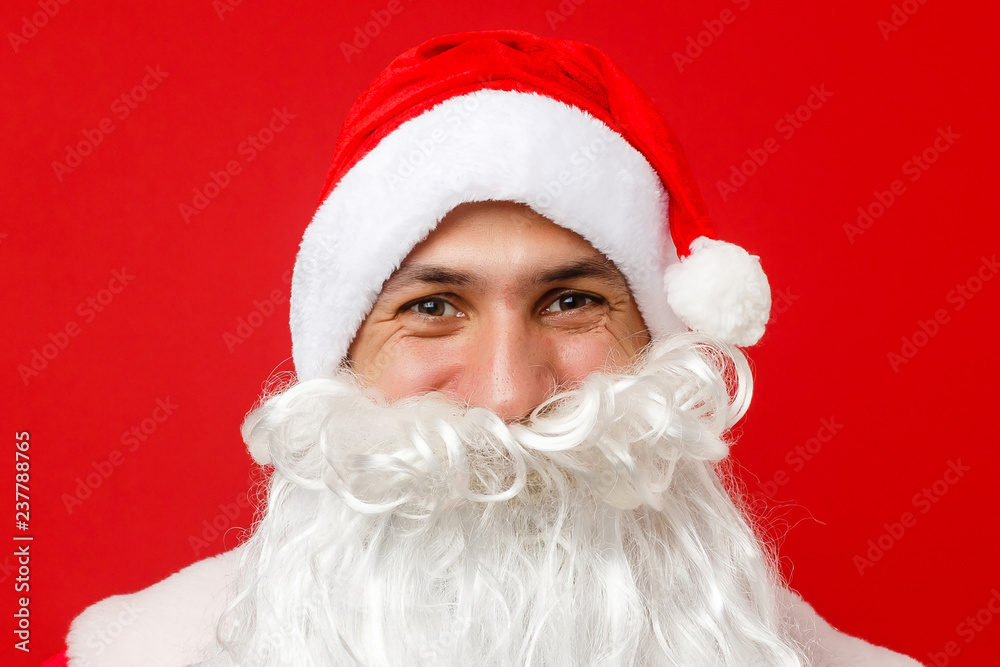 Santa Claus looking into the camera with traditional background and hands crossed in front of him Santa Claus looking into the camera with traditional background and hands crossed in front of him