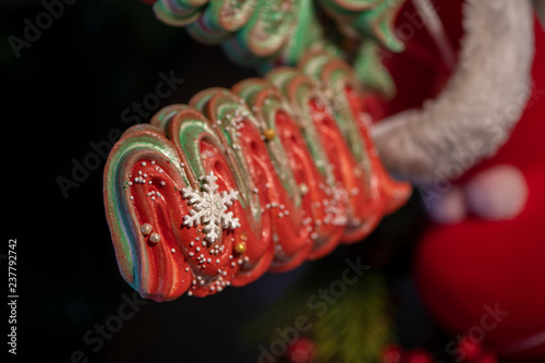 Various Christmas sweets and candies with christmas tree on wood table