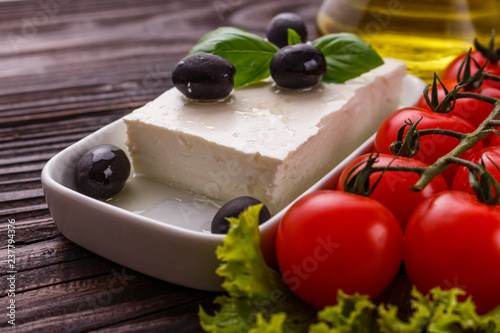 A piece of feta cheese on a wooden rustic background