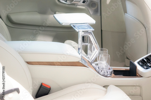 Bottle of champagne glass closeup in expensive car