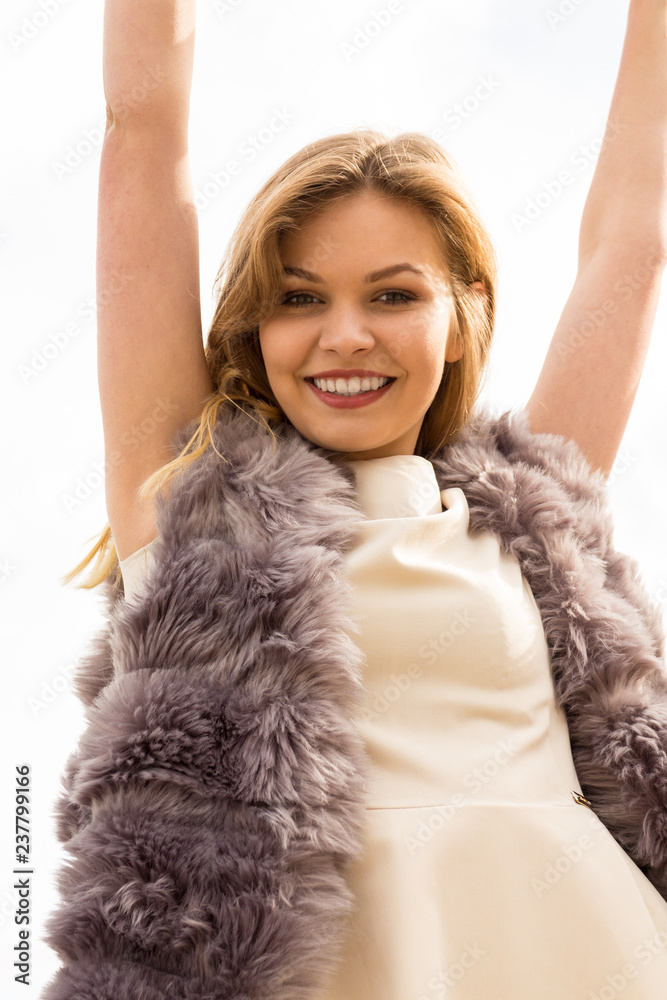Happy woman outdoor wearing fur vest Happy woman outdoor wearing fur vest