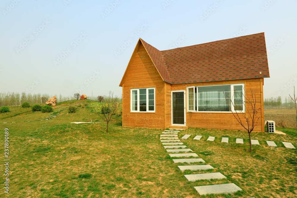 Fototapeta premium wooden house and stone path