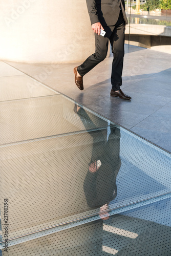 Business person walking on glass flooring