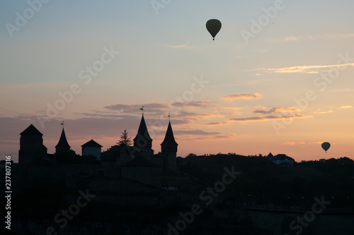 silhouette of air balloon parade over Kamianets-Podilskyi Castle in Ukraine