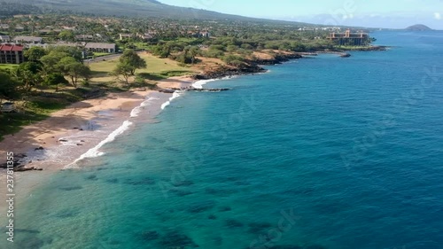 Aerial footage of Kamaole III Beach with Wailea and Makena areas in the background.  Maui, Hawaii. photo