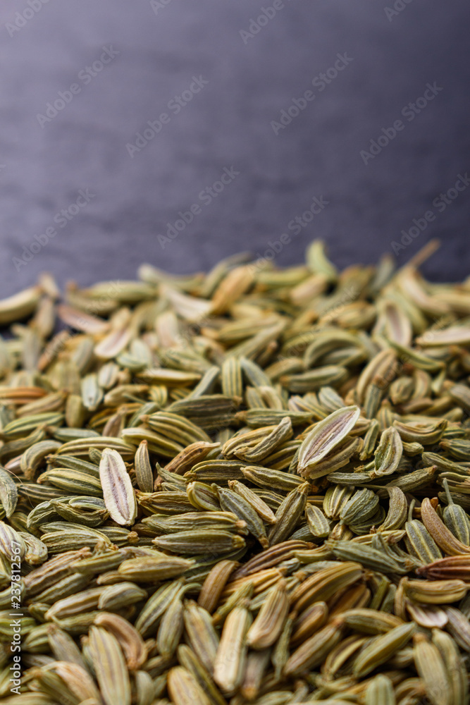 Essential oil of fennel seeds on a dark stone background Essential oil of fennel seeds on a dark stone background