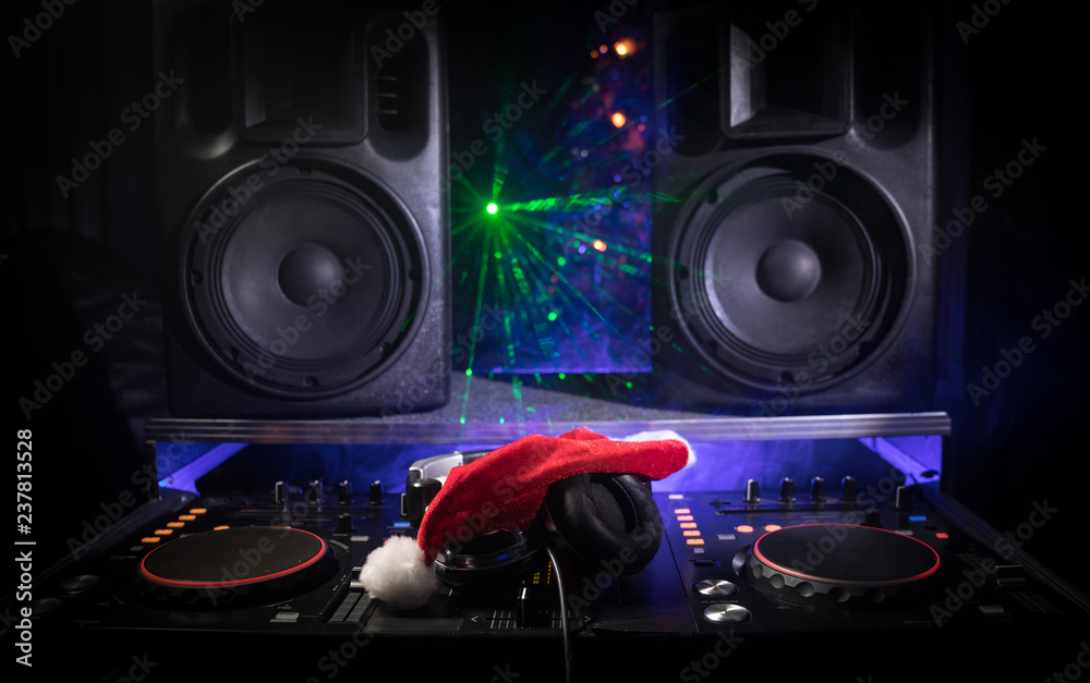 Dj mixer with headphones on dark nightclub background with Christmas tree  New Year Eve. Close up view of New Year elements on a Dj table. Holiday  party concept. Stock Photo | Adobe